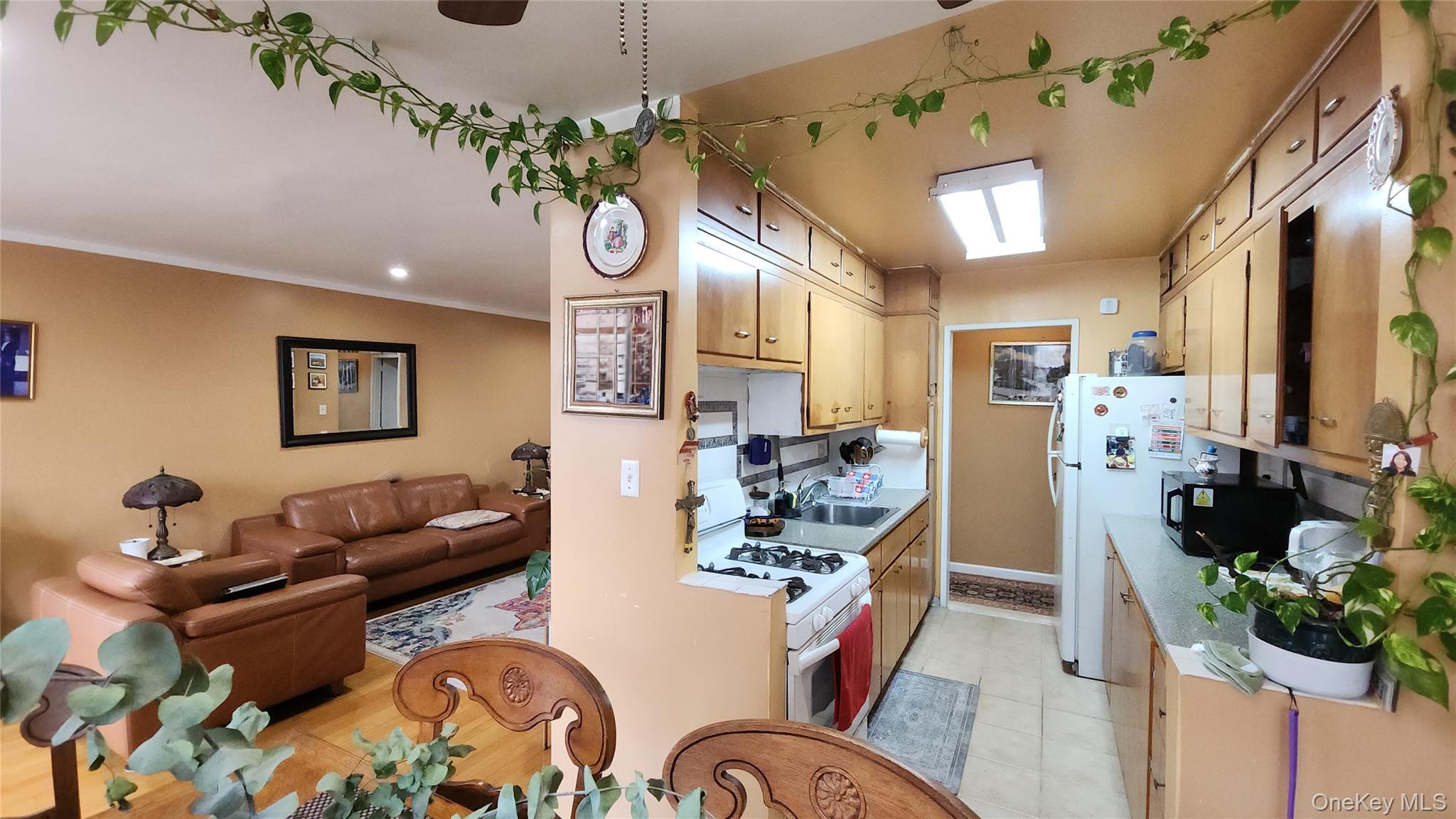 99-10 60th Avenue, Unit 3H Queens, NY 11368 - Photo 25 of 25 a living room with furniture a chandelier and a dining table