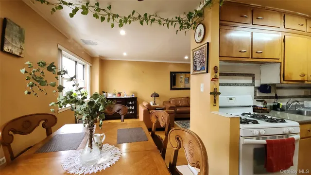 a living room with furniture a chandelier and a dining table