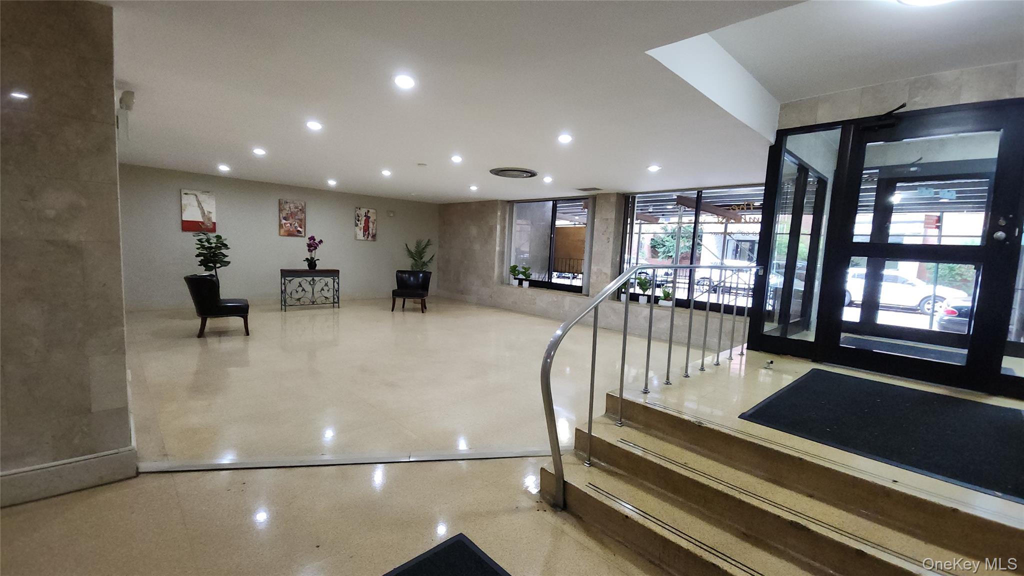 99-10 60th Avenue, Unit 3H Queens, NY 11368 - Photo 20 of 25 a view of a lobby with black carpet