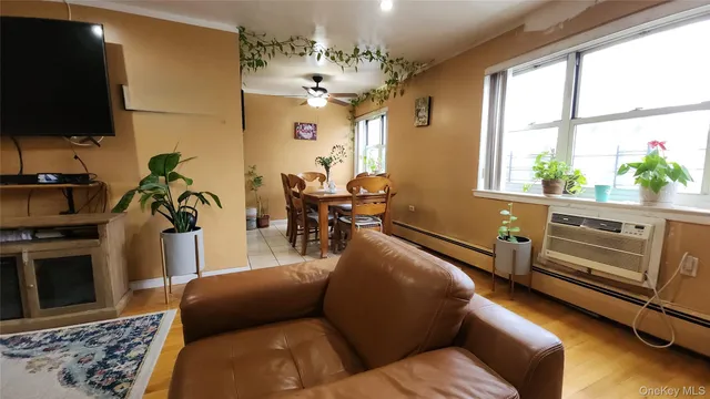 a living room with furniture a chandelier and a flat screen tv