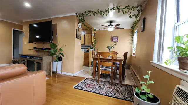 a living room with furniture kitchen view and a chandelier