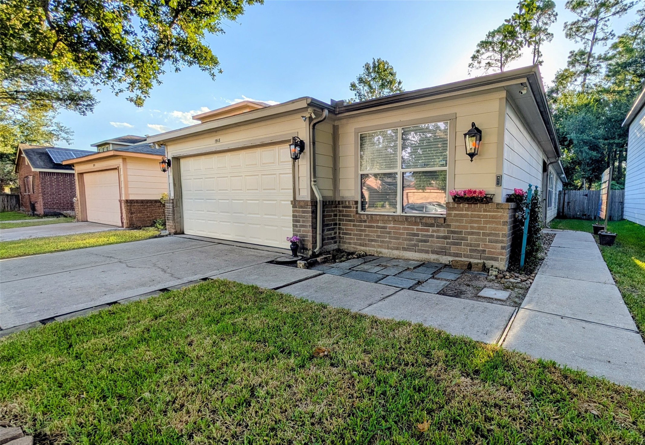 1918 Adobe Stone Drive Humble, TX 77396 - Photo 2 of 16 a front view of a house with a yard and garage