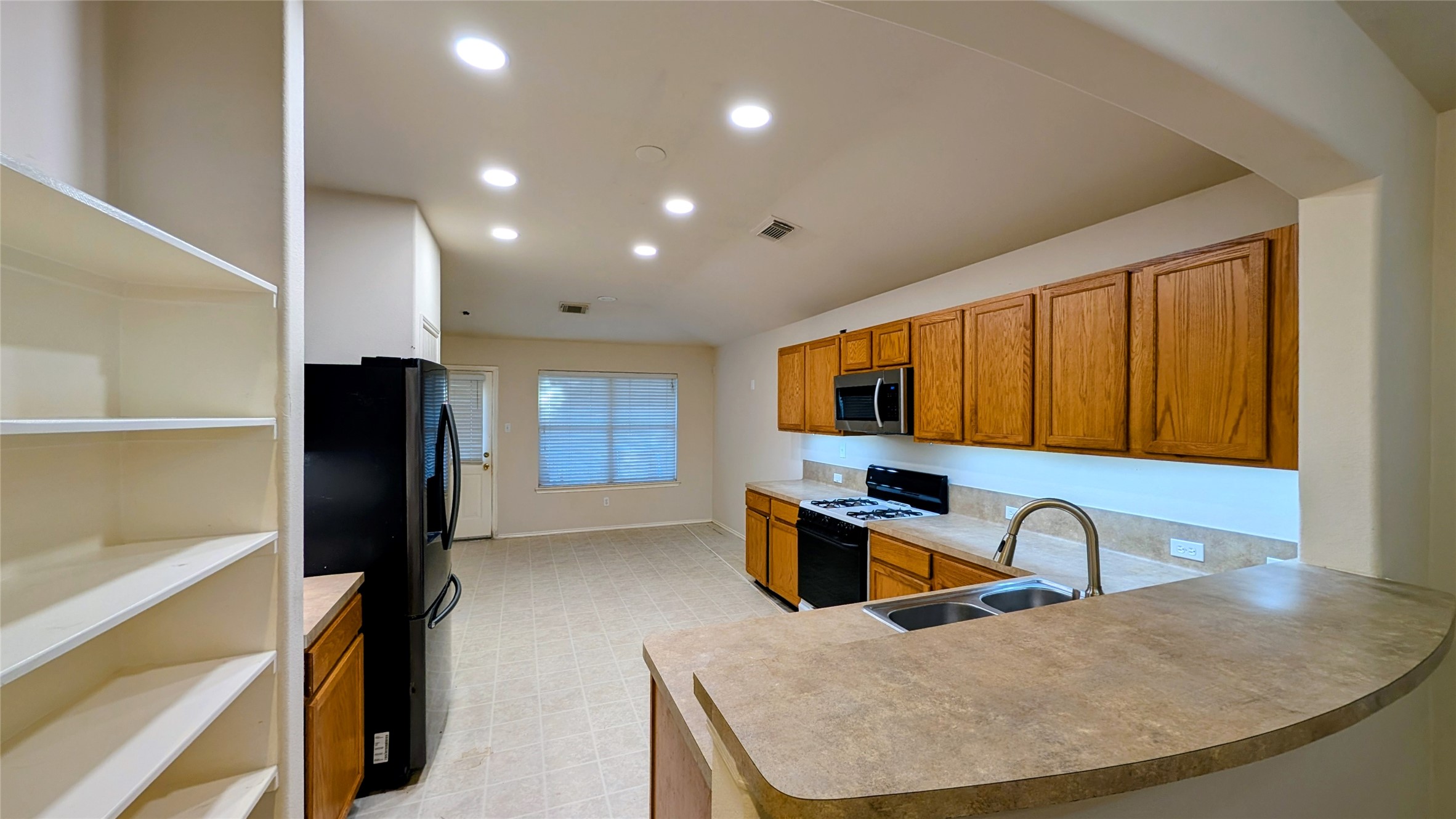 1918 Adobe Stone Drive Humble, TX 77396 - Photo 8 of 16 a kitchen with a refrigerator and a sink