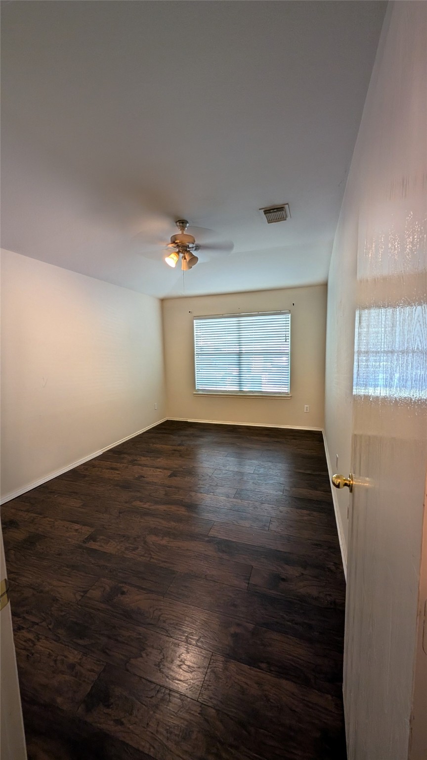 1918 Adobe Stone Drive Humble, TX 77396 - Photo 9 of 16 an empty room with wooden floor and windows