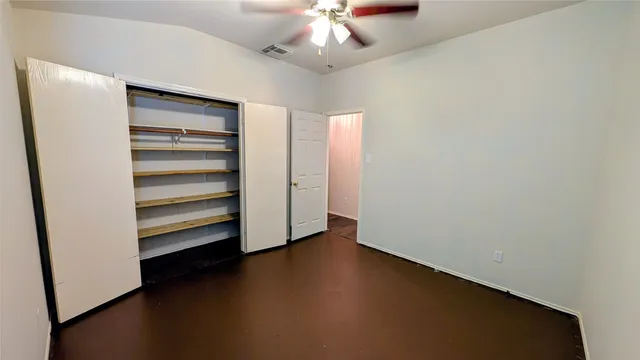 a view of walk in closet with empty racks