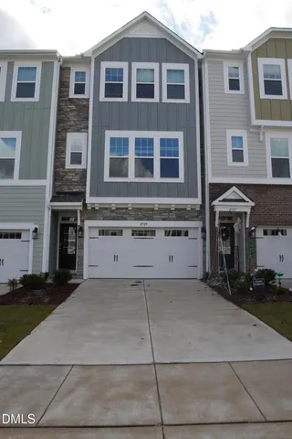 a view of a brick house with many windows