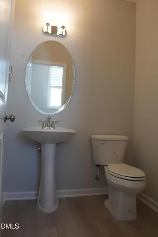 a bathroom with a shower a toilet and a sink