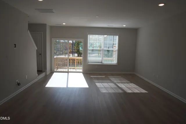 a kitchen with stainless steel appliances a refrigerator sink and white cabinets