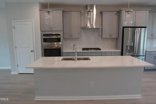 a stove top oven sitting inside of a kitchen