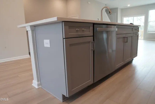 a kitchen with a refrigerator sink and cabinets