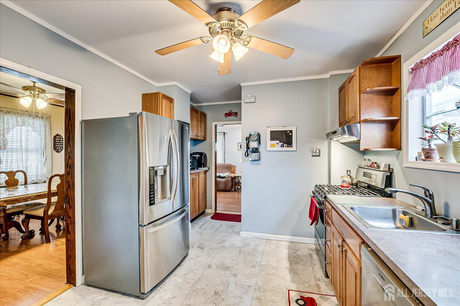 7 Clum Avenue Fords, NJ 08863 - Photo 15 of 43 a kitchen with stainless steel appliances granite countertop a refrigerator a stove a sink a dining table and chairs with wooden floor