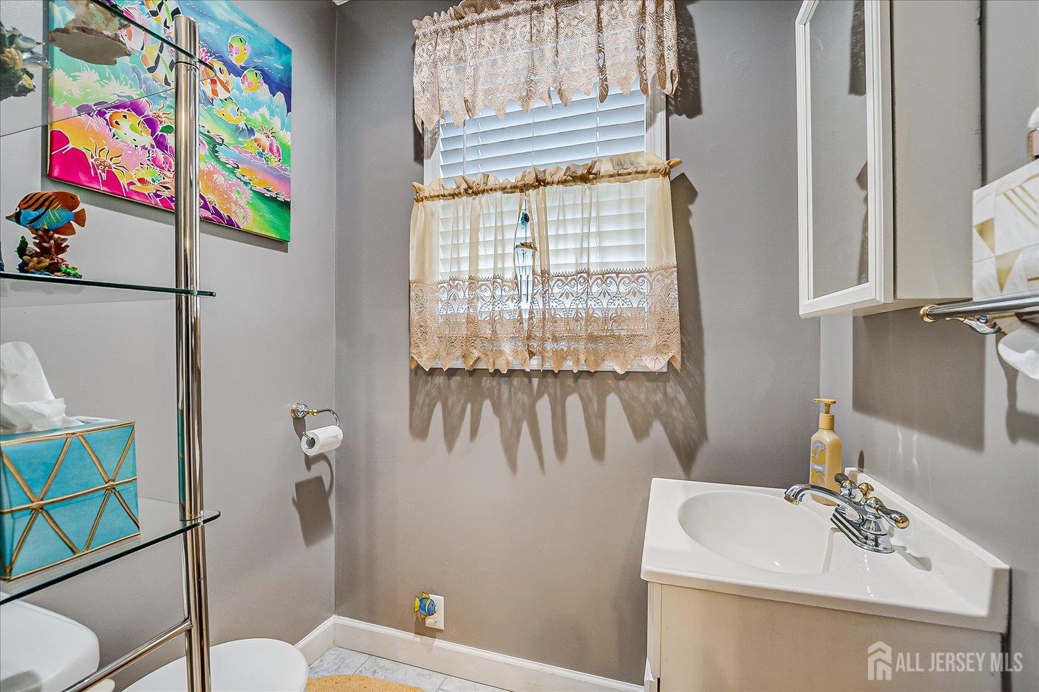 7 Clum Avenue Fords, NJ 08863 - Photo 19 of 43 a bathroom with a sink a toilet and a shower curtain