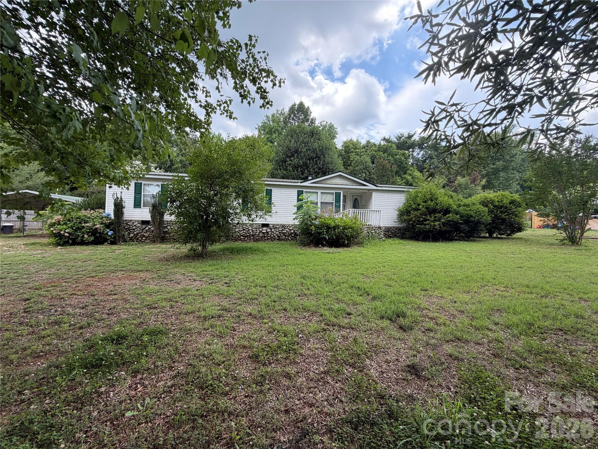 43702 Cypress Crossing Road New London, NC 28127 - Photo 1 of 12 a house view with a garden space