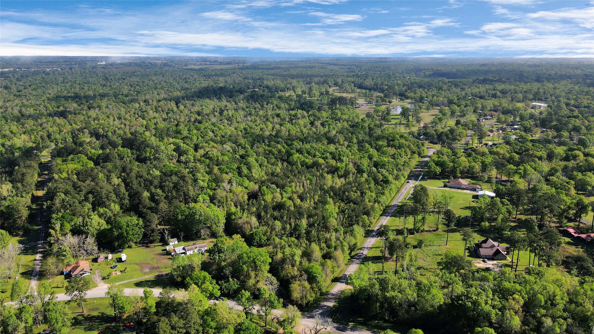 938 Minglewood Road Liberty, TX 77575 - Photo 3 of 16 a view of a city with lush green forest