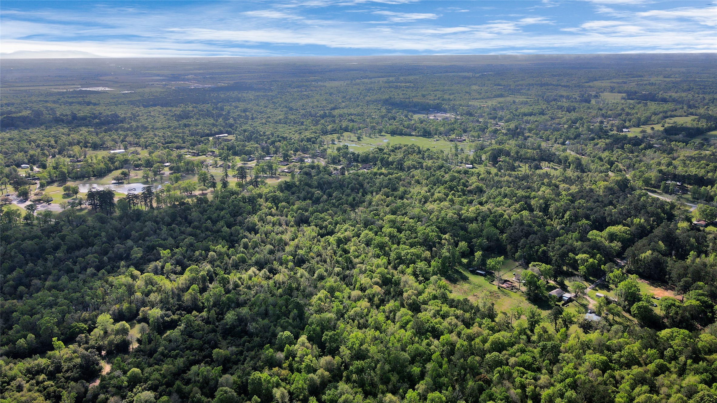 938 Minglewood Road Liberty, TX 77575 - Photo 5 of 16 a view of a city with lush green forest