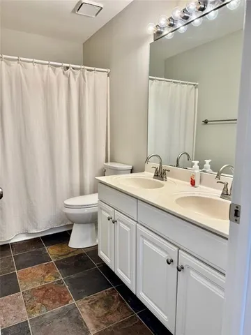 a living room with furniture a piano and a chandelier