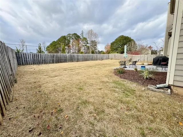 a front view of a house with a yard covered with snow