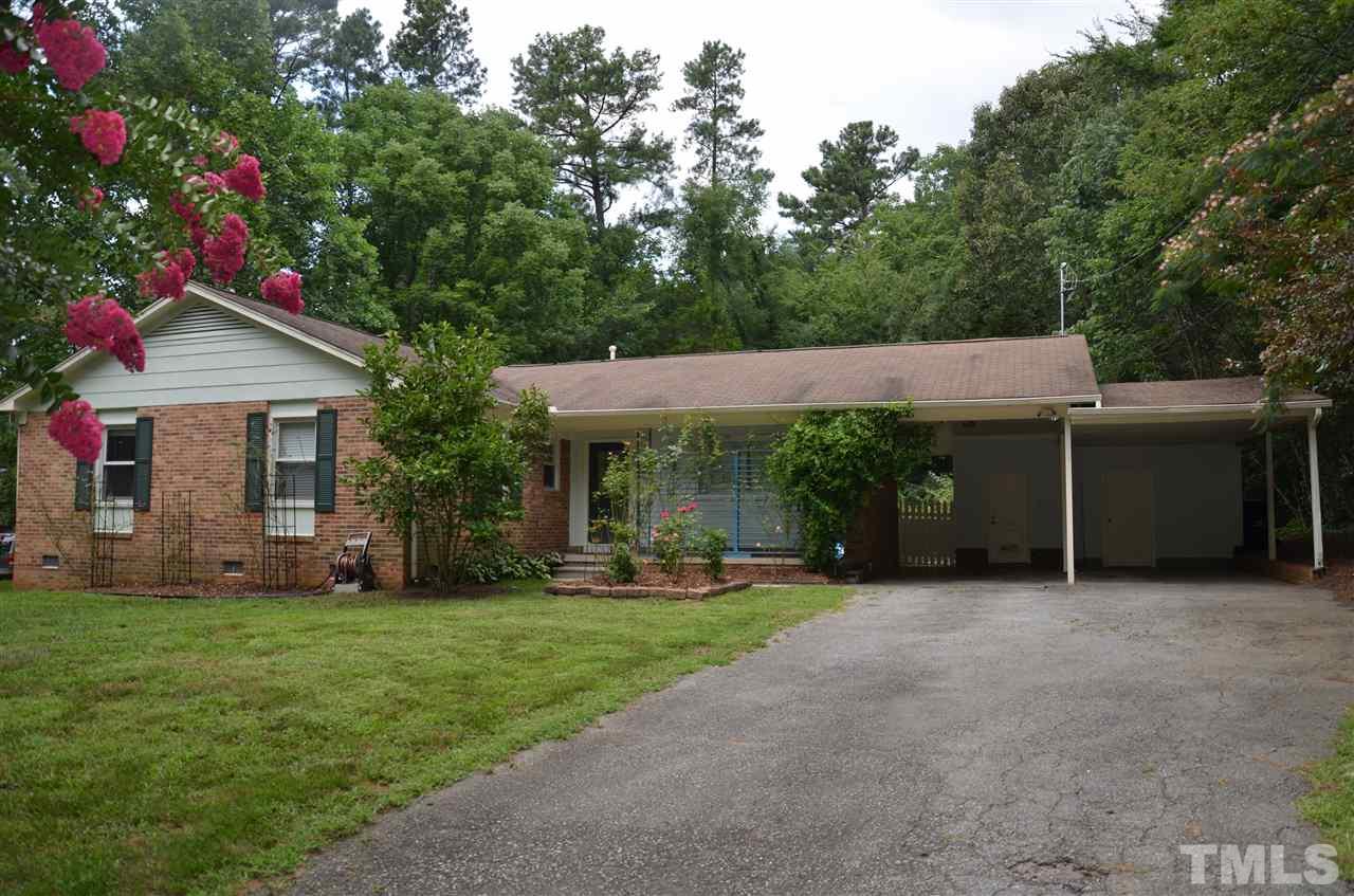 4604 Blanchard Road Durham, NC 27713 - Photo 1 of 25 a front view of a house with a garden and trees