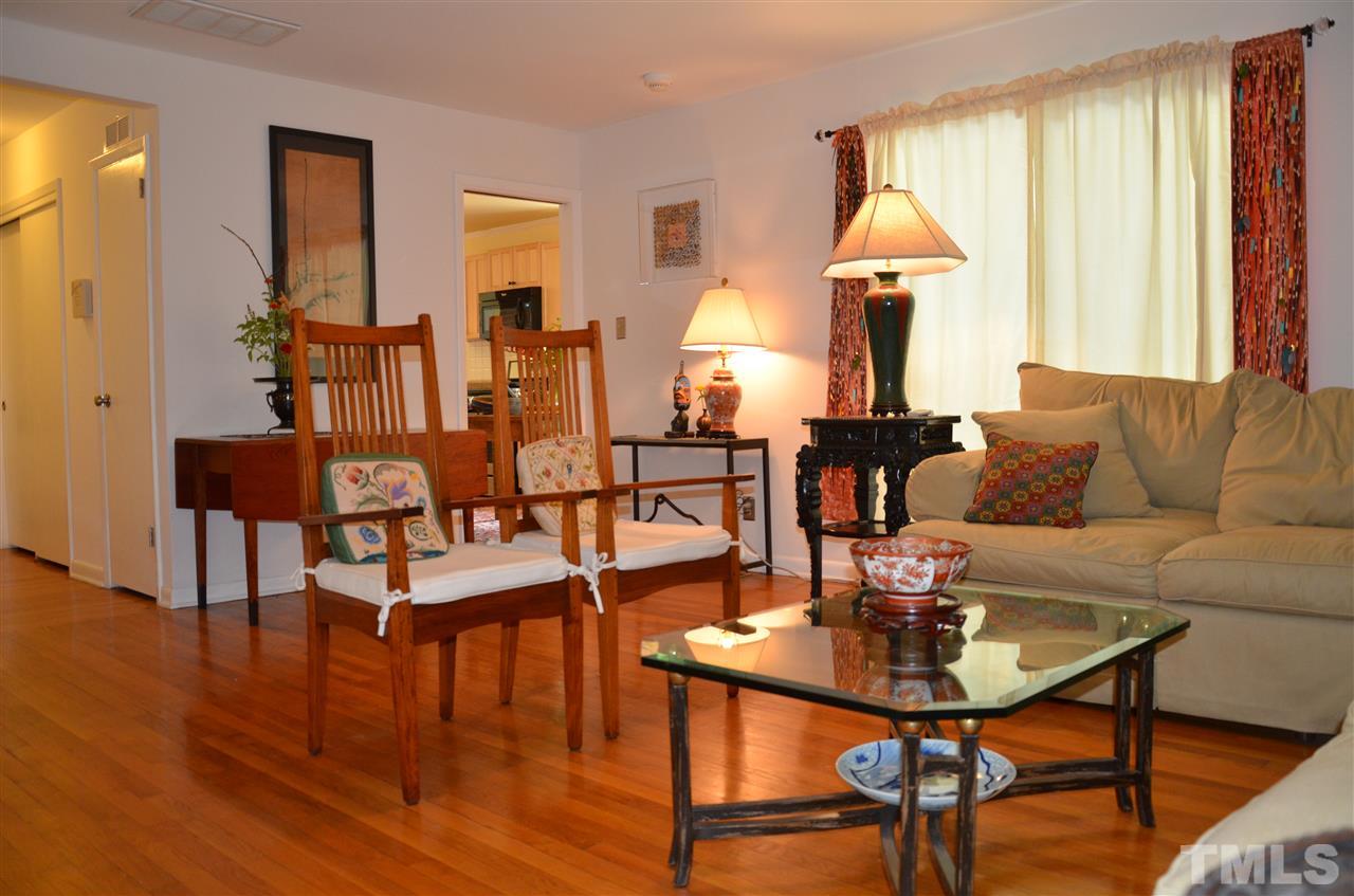 4604 Blanchard Road Durham, NC 27713 - Photo 4 of 25 a living room with couches a table and chairs with wooden floor