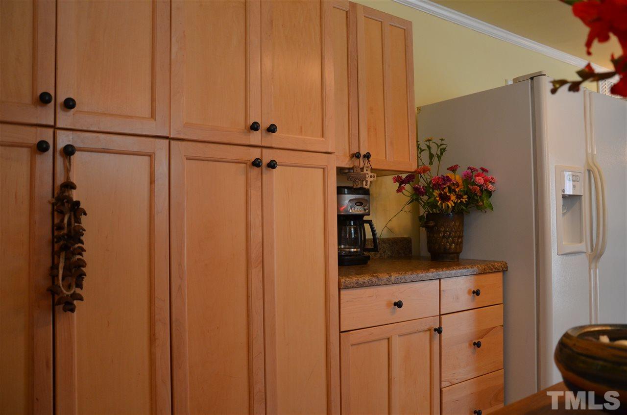 4604 Blanchard Road Durham, NC 27713 - Photo 7 of 25 a kitchen with a refrigerator and cabinets
