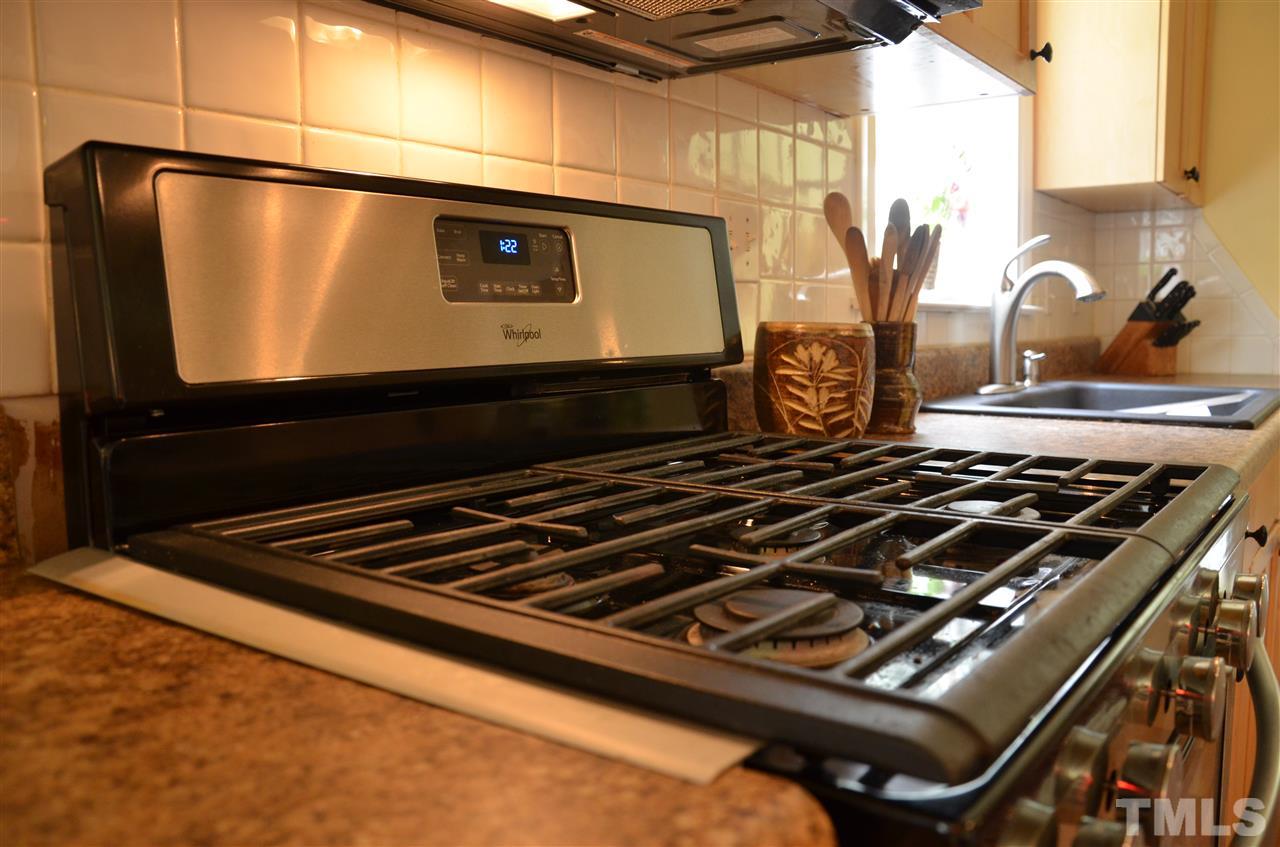 4604 Blanchard Road Durham, NC 27713 - Photo 10 of 25 a stove top oven sitting inside of a kitchen