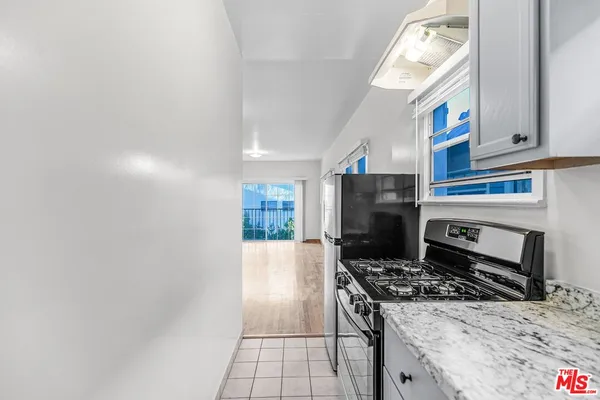 a kitchen with a stove and a refrigerator