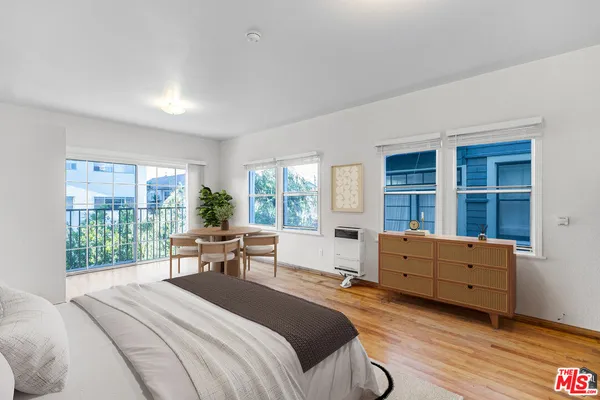 a bedroom with a bed and large window