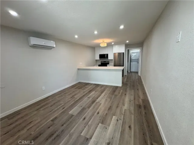 a view of kitchen with sink and wooden floor