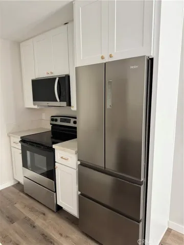 a white refrigerator freezer and a stove sitting inside of a kitchen