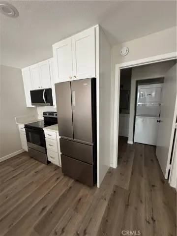 a kitchen with a refrigerator and a sink