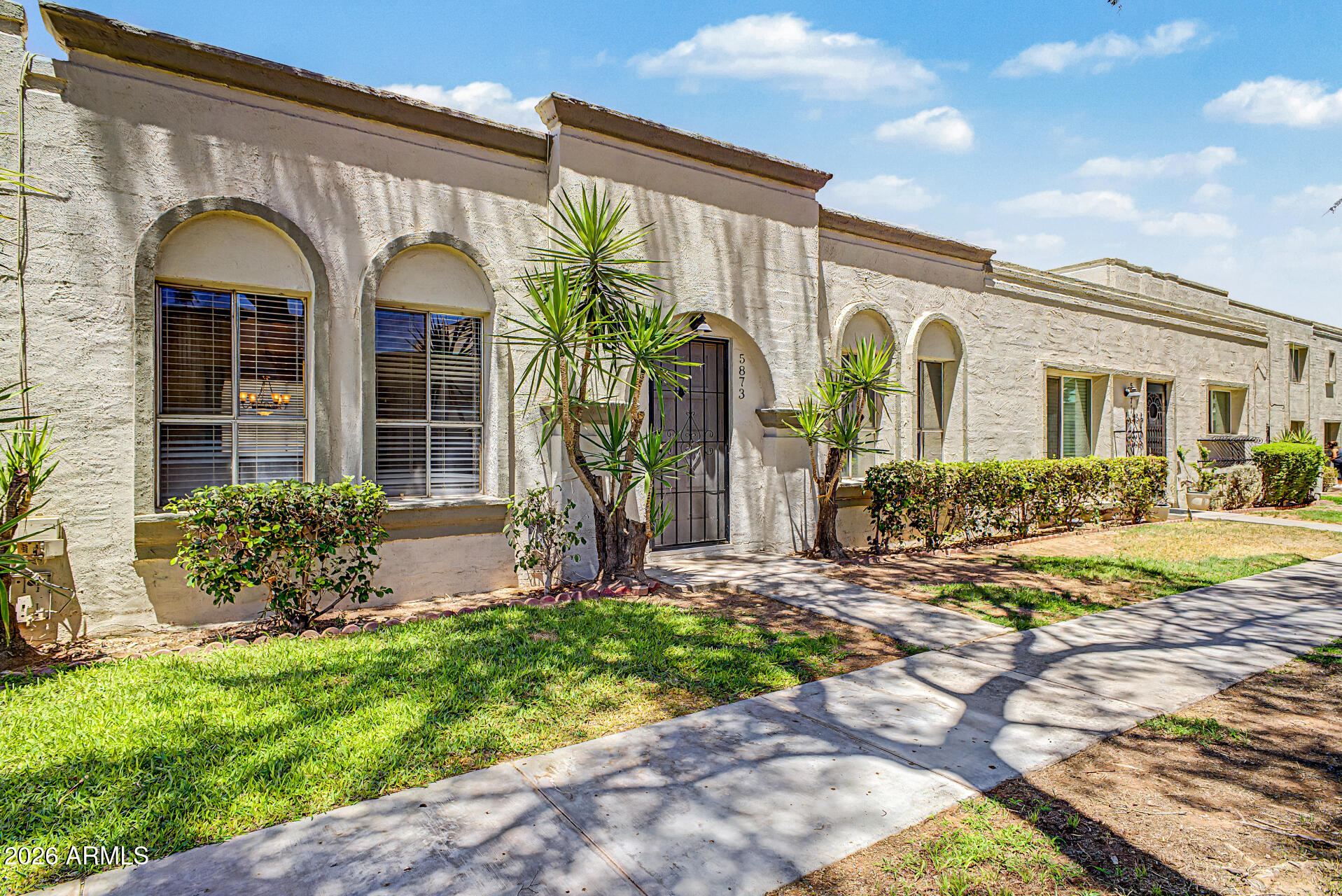 a front view of a house with garden