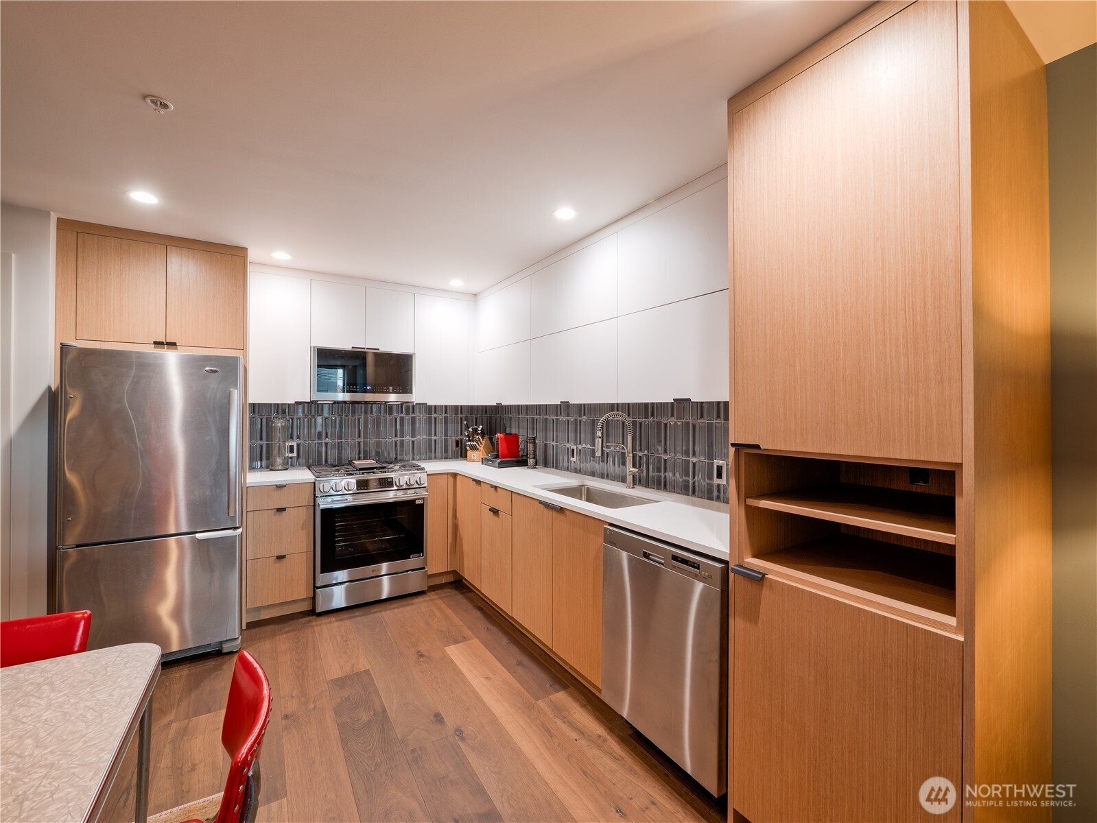 910 Lenora Street, Unit 200 Seattle, WA 98121 - Photo 4 of 23 a kitchen with stainless steel appliances a refrigerator and a stove top oven