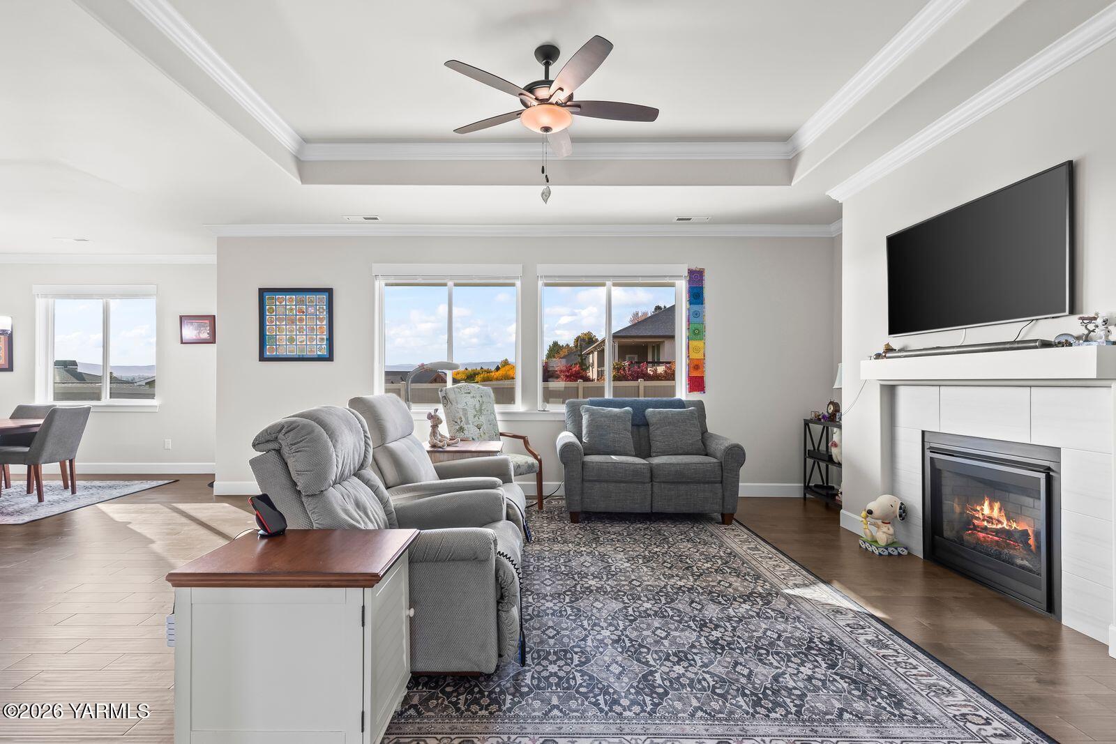 304 Rainier Street Yakima, WA 98908 - Photo 20 of 39 a living room with furniture a fireplace and a flat screen tv
