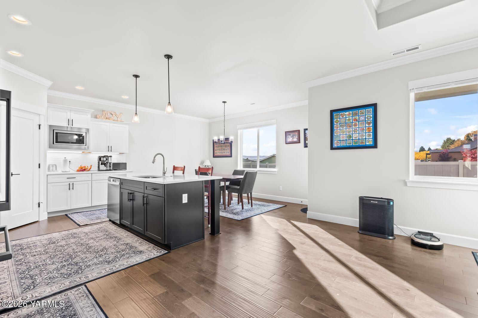304 Rainier Street Yakima, WA 98908 - Photo 26 of 39 a large white kitchen with lots of counter space a sink appliances and cabinets