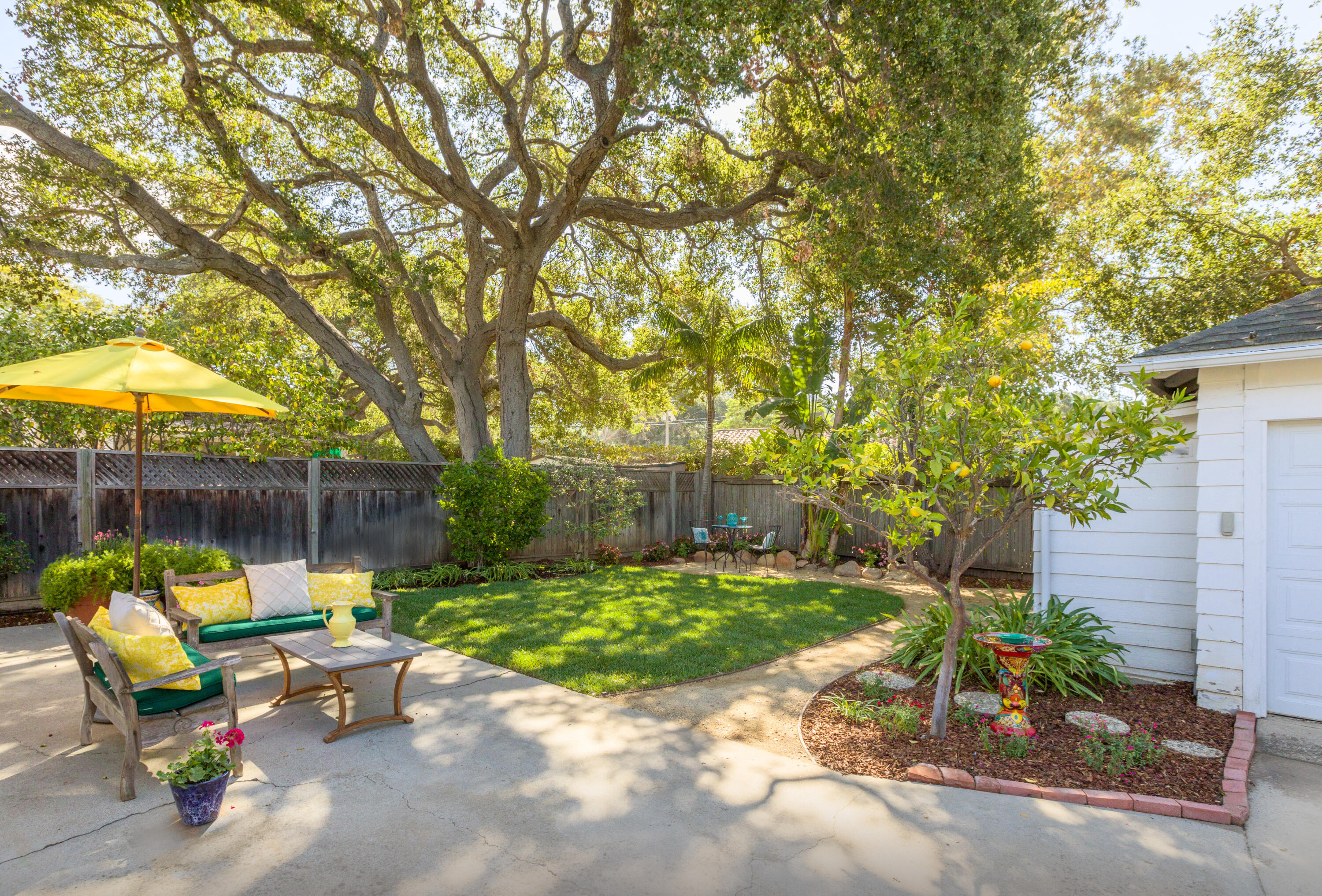 2721 Verde Vista Drive Santa Barbara, CA 93105 - Photo 13 of 21 a view of patio with table and chairs under an umbrella with large trees