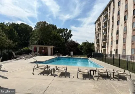 a view of backyard with swimming pool outdoor seating and barbeque oven