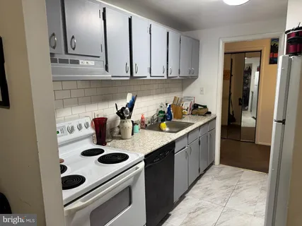 a kitchen with a sink a stove and refrigerator