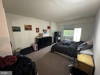 a bedroom with a bed and window