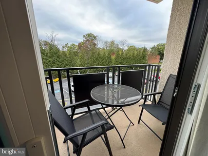 a view of a balcony with chairs and a table