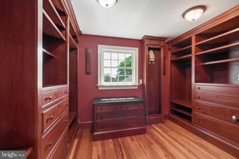 a view of entryway and hall with wooden floor