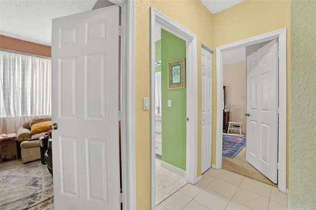 a view of a hallway with furniture and closet