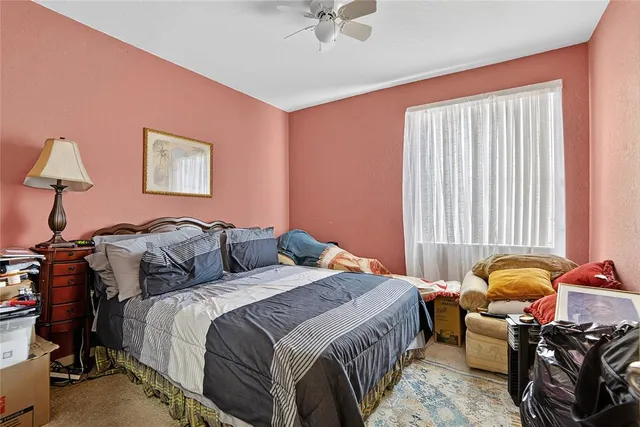 a bedroom with bed and a window