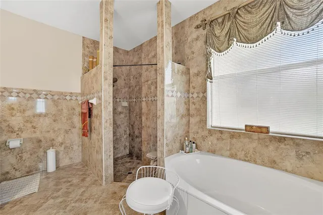 a bathroom with a bathtub and a shower