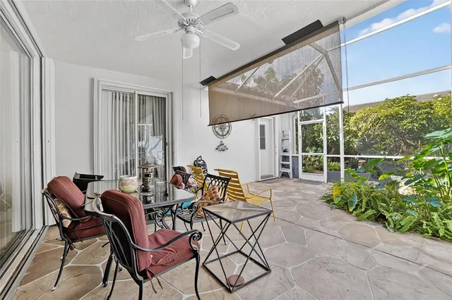 a view of a patio with table and chairs and potted plants