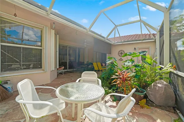 a dining room with furniture and a potted plant