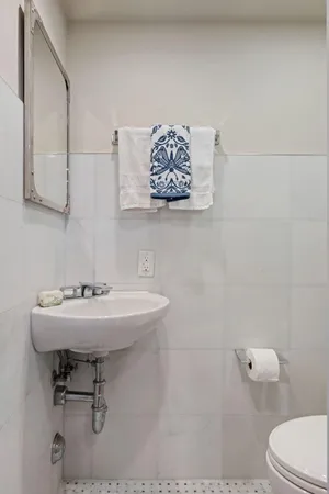 a bathroom with a sink a toilet and mirror