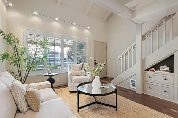 a living room with furniture and a floor to ceiling window