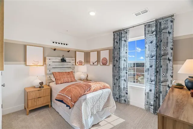 a bedroom with a bed couch and a window