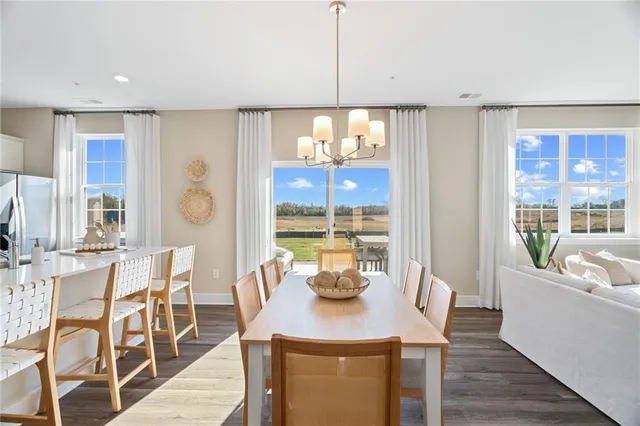 a view of a dining room with furniture and window