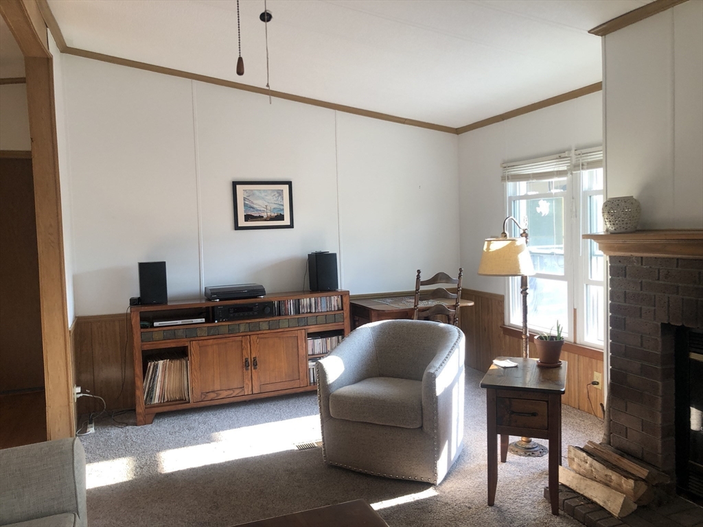 41 Pipers Way Carver, MA 02330 - Photo 7 of 36 a living room with furniture a fireplace and a flat screen tv